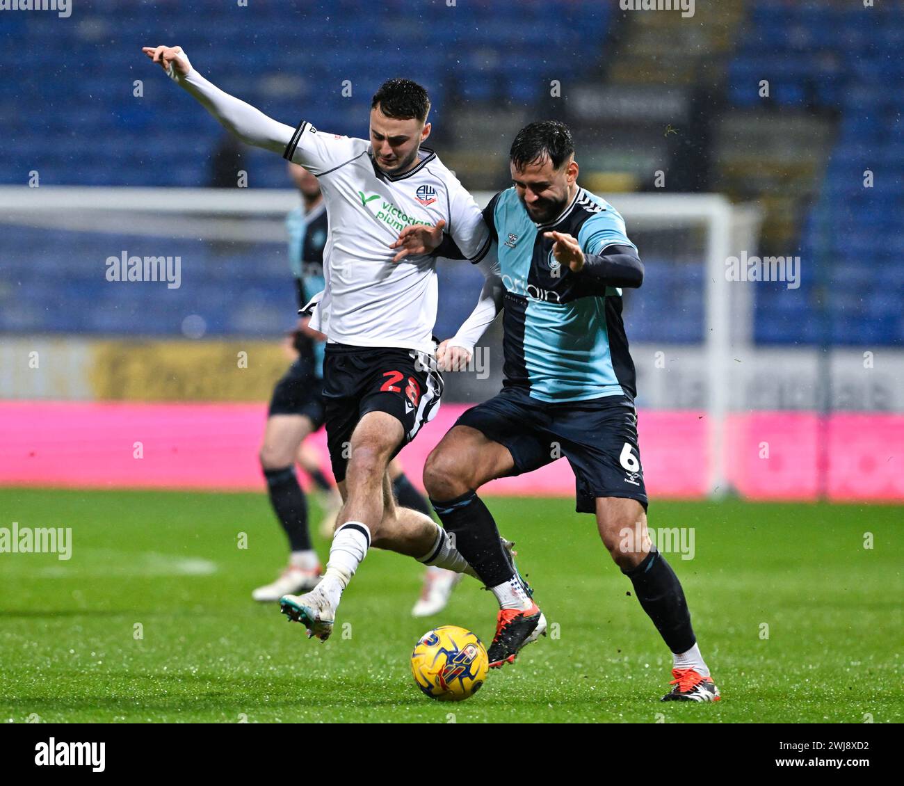 Ryan Tafazolli of Wycombe Wanderers and Aaron Collins of Bolton Wanderers battle for the ball, during the Sky Bet League 1 match Bolton Wanderers vs Wycombe Wanderers at Toughsheet Community Stadium, Bolton, United Kingdom, 13th February 2024  (Photo by Cody Froggatt/News Images) Stock Photo
