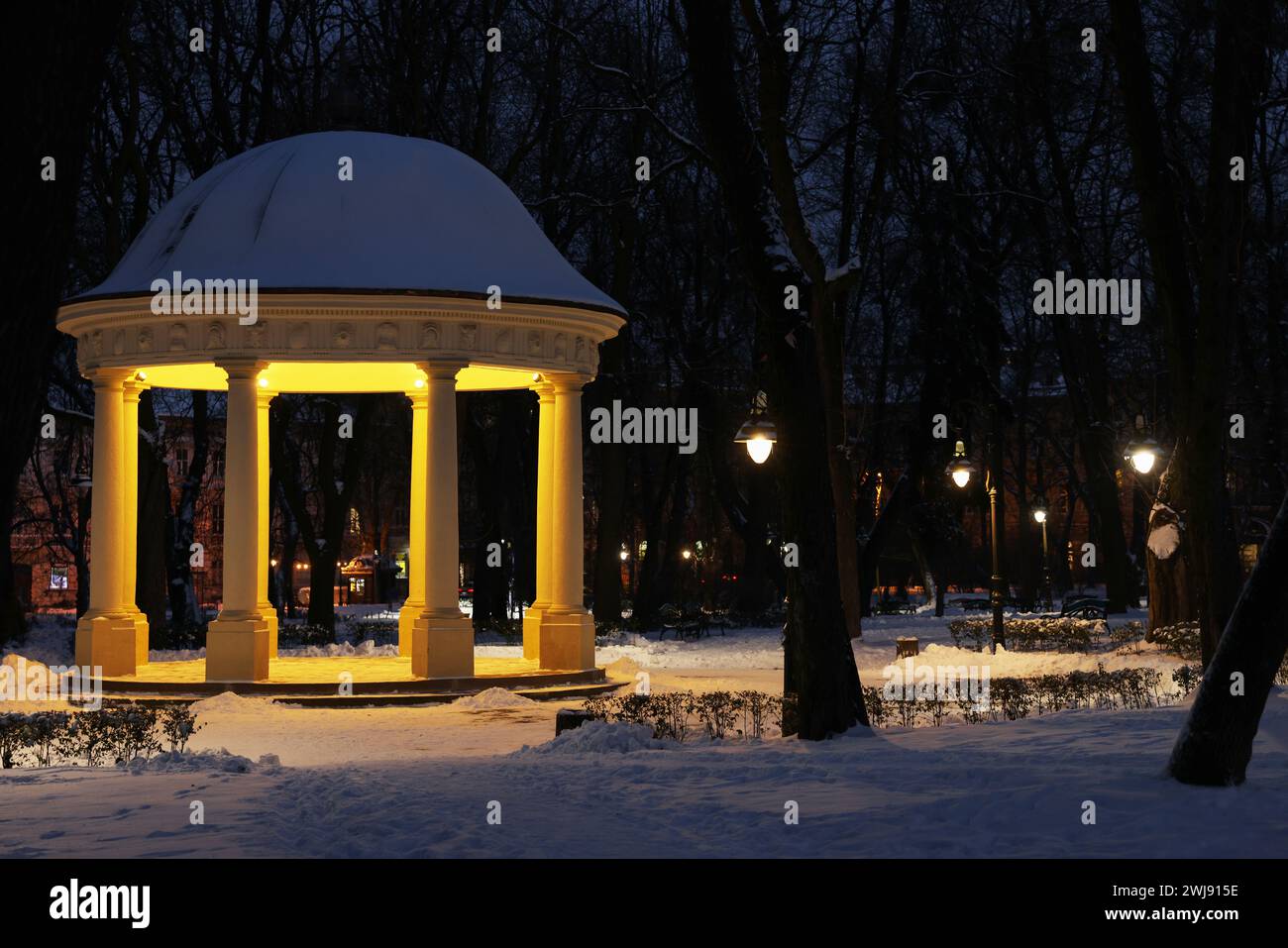 Trees, street lamps, gazebo and snow in evening park Stock Photo - Alamy