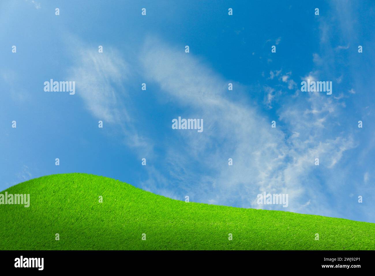 Lush green grass under blue sky with clouds Stock Photo - Alamy