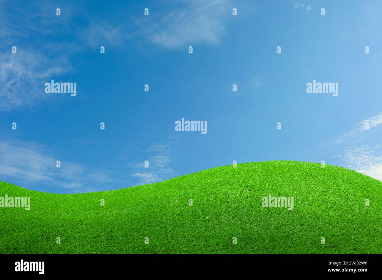Lush green grass under blue sky with clouds Stock Photo - Alamy
