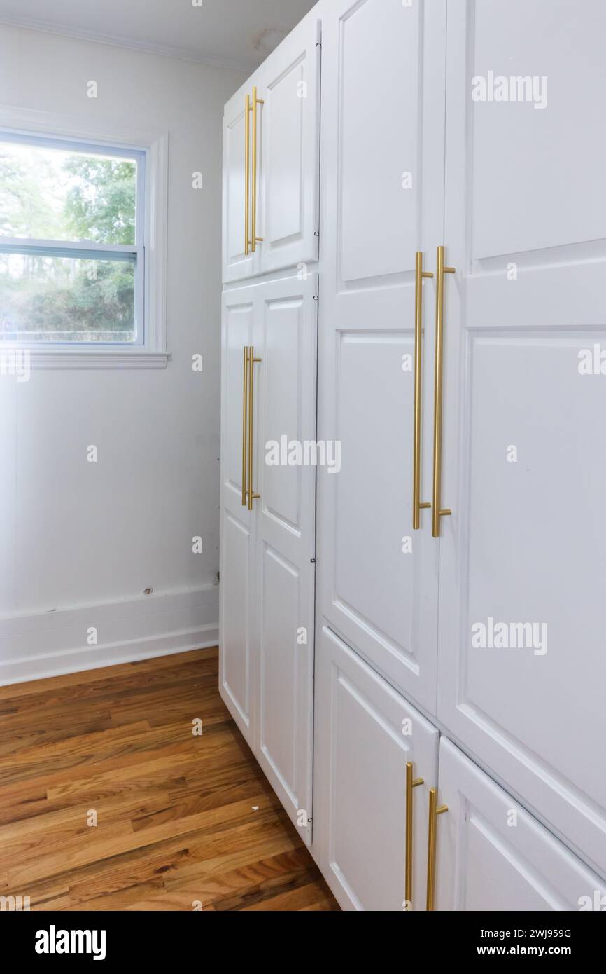 Updated white shaker cabinets with elegant gold sleek thin hardware in ...