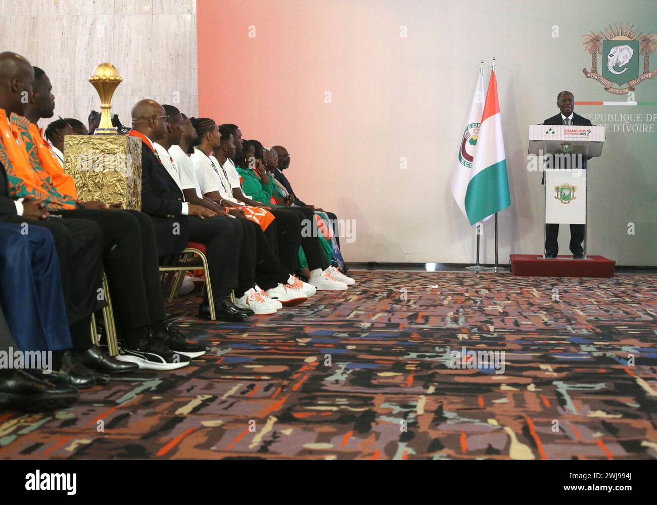 Abidjan, Cote d'Ivoire. 13th Feb, 2024. Cote d'Ivoire President Alassane Ouattara (1st R) speaks during a ceremony awarding the Cote d'Ivoire national football team at the Presidential Palace in Abidjan, Cote d'Ivoire, Feb. 13, 2024. Cote d'Ivoire won the 2023 Africa Cup of Nations (AFCON) on Sunday in Abidjan, beating Nigeria 2-1 in the final. Credit: Yvan Sonh/Xinhua/Alamy Live News Stock Photo