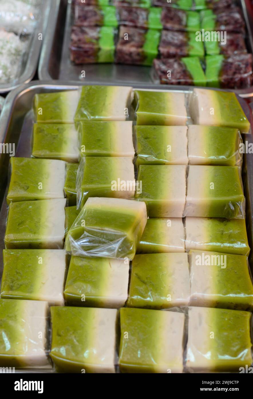 Seri Muka is a two-layered dessert with steamed glutinous rice forming the bottom half and a green custard layer made with pandan juice & coconut milk Stock Photo