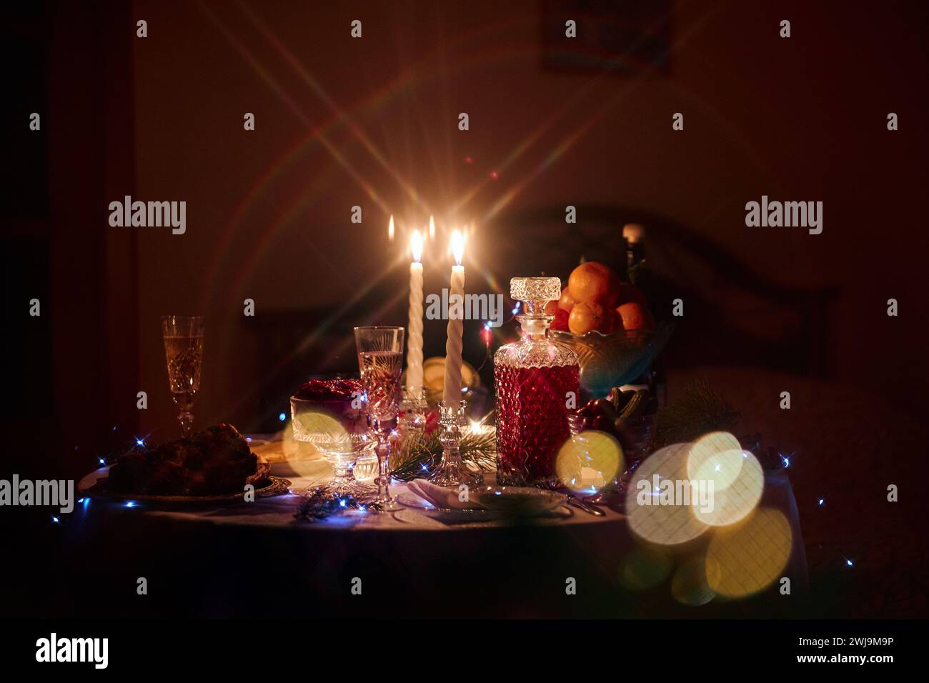 Beautiful retro holiday decor, birthday party. Burning candles and lights in the dark, Christmas Stock Photo
