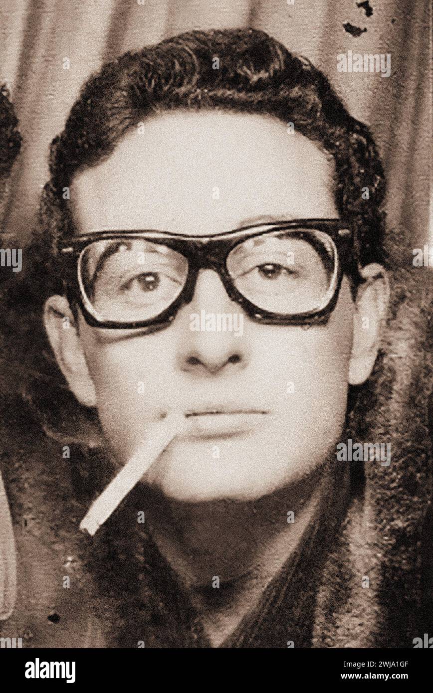 A smoking Buddy Holly photographed in a photo-booth in Central Station, in New York City, 1959 - vintage Stock Photo