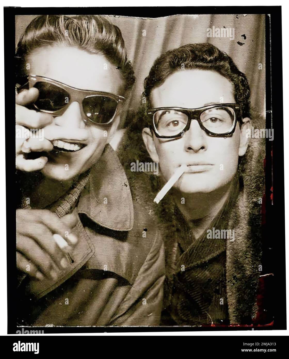 Buddy Holly and Waylon Jennings photographed in a photo-booth in Central Station, in New York City. 1959. Stock Photo