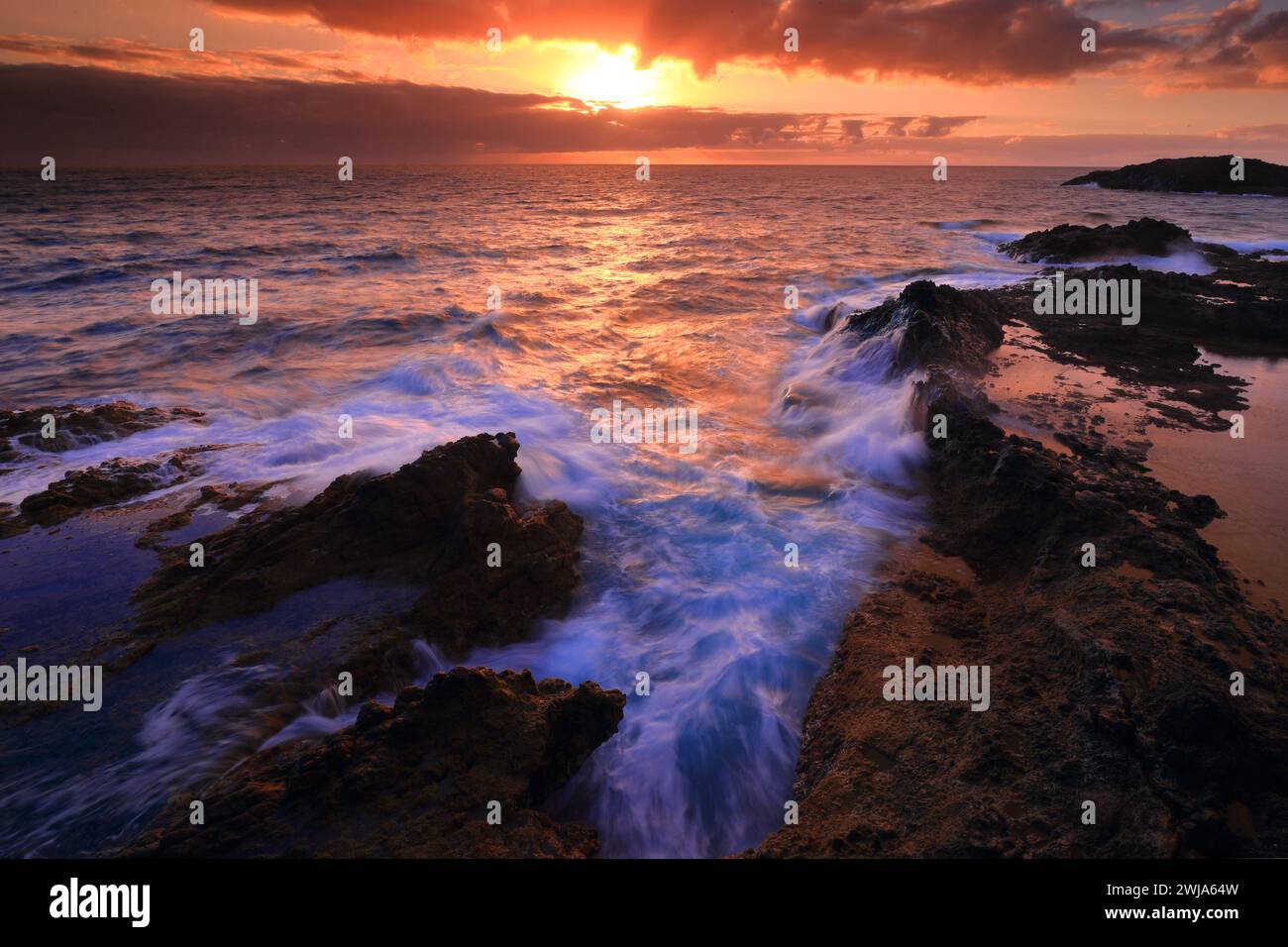 Sunset over rocky coastline hi-res stock photography and images - Alamy