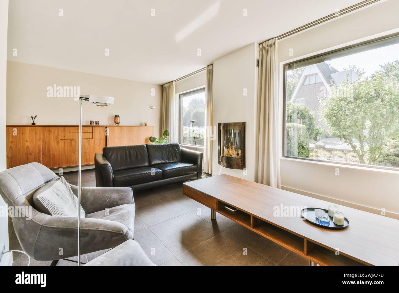 Spacious modern living room with large windows, providing ample natural ...