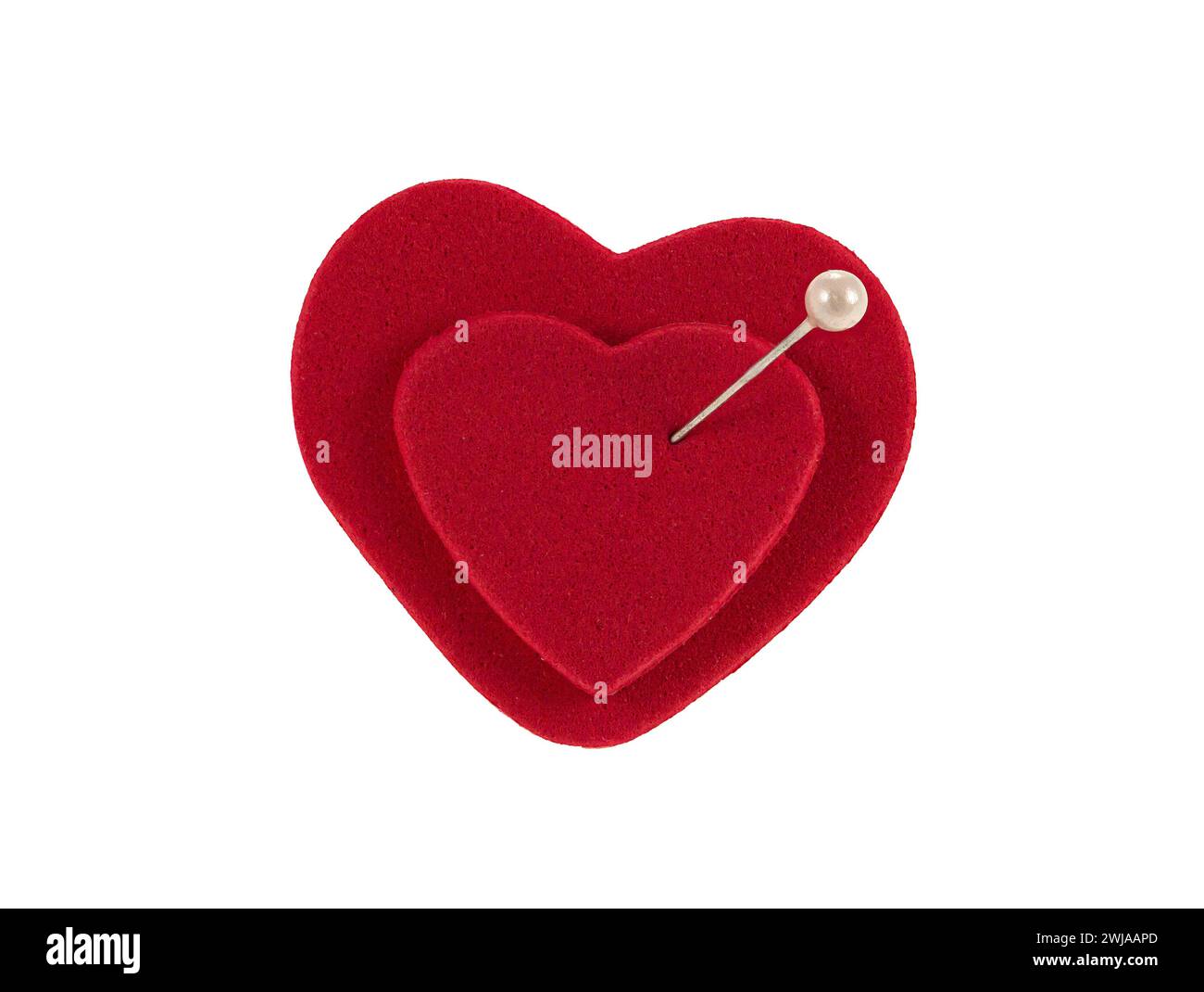 Two red hearts joined by a pin as a concept of marriage and eternal love. Stock Photo