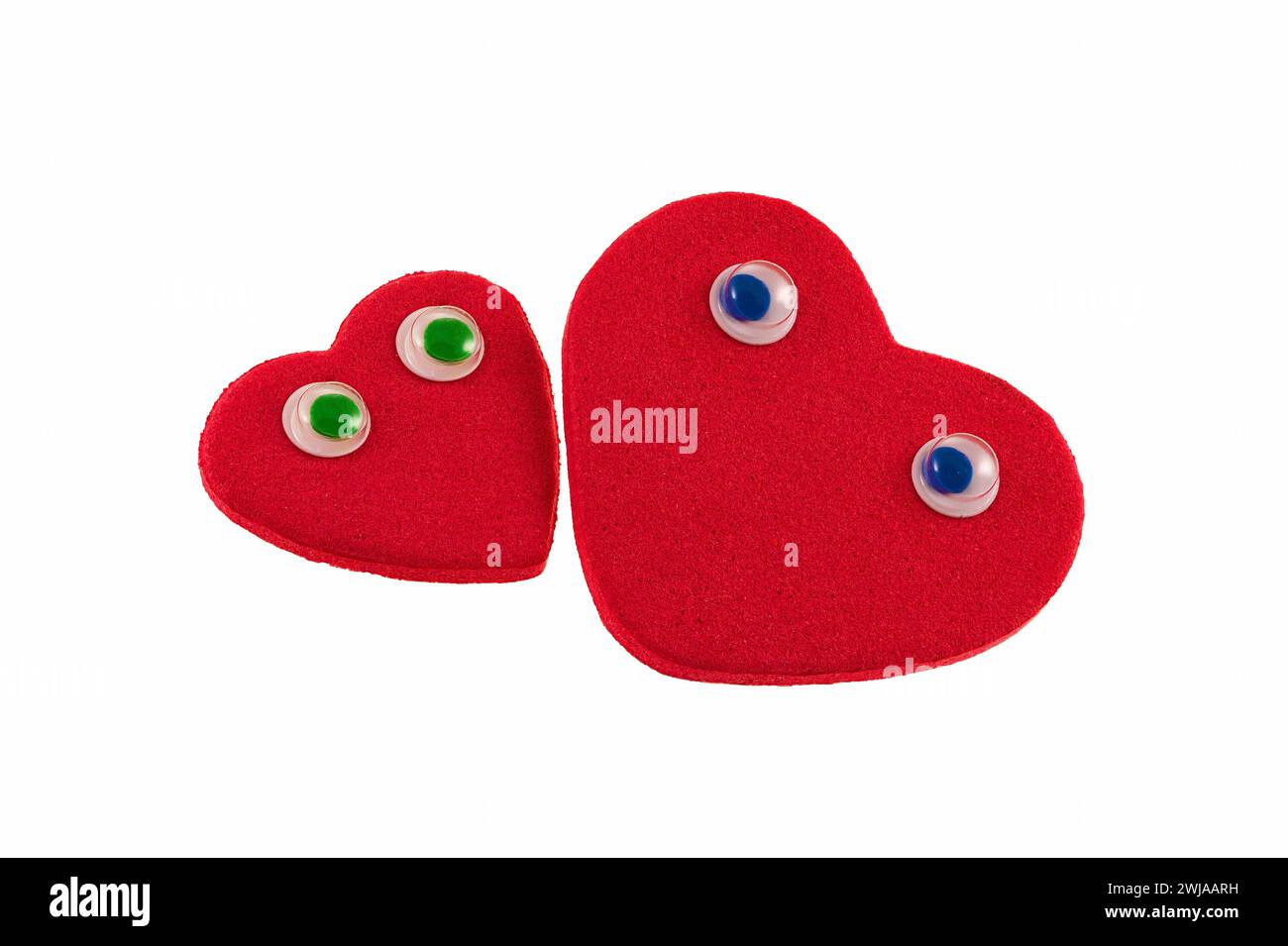 Two red hearts look at each other with love and desire. Stock Photo