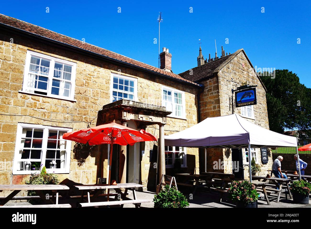 Front view of the Dolphin Inn along Silver Street in the town centre with the top of the minster to the rear, Ilminster, Somerset, UK. Stock Photo