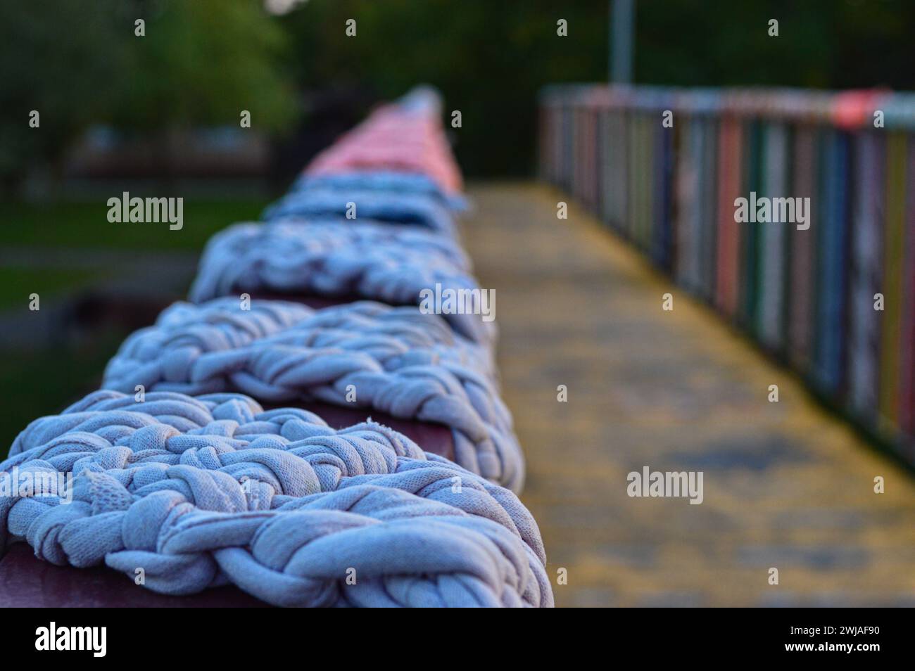 A closeup of yarn wrapped on a bridge railing Stock Photo