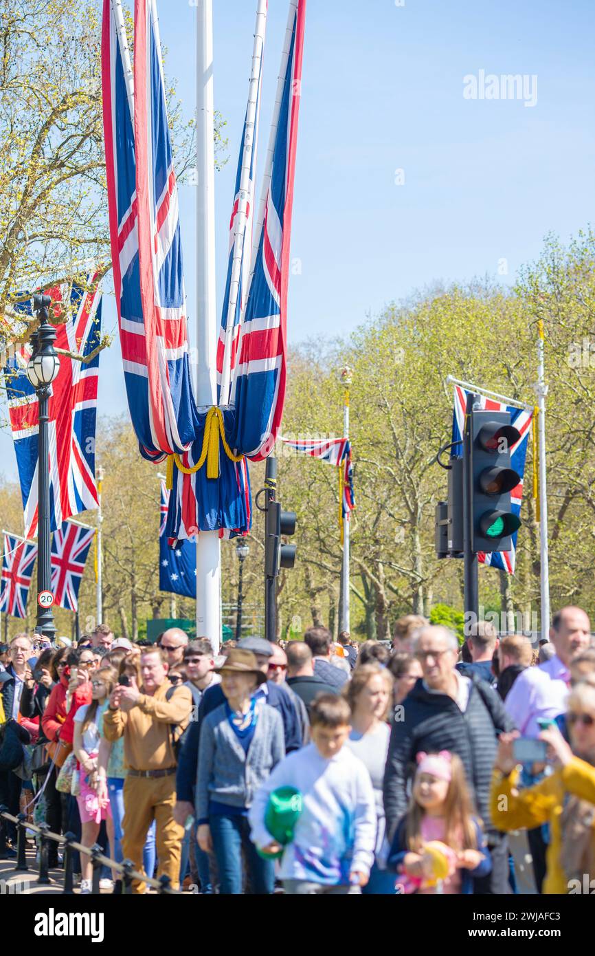 People take photographs near Buckingham Palace as London prepares for the coronation of King Charles III. Stock Photo