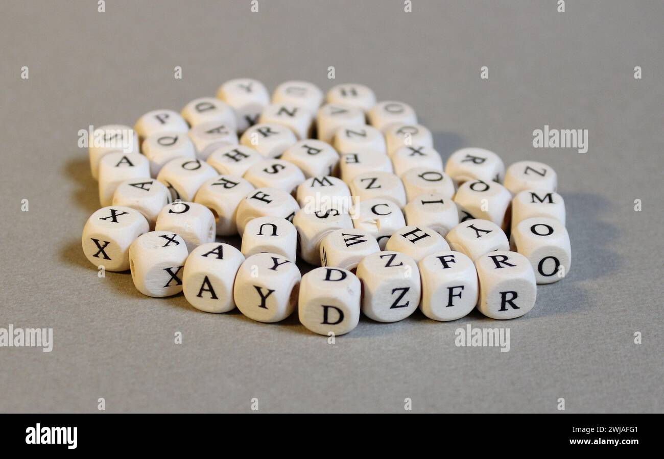 Wooden cubes with letters on the light gray background. Graphic elements. Stock Photo