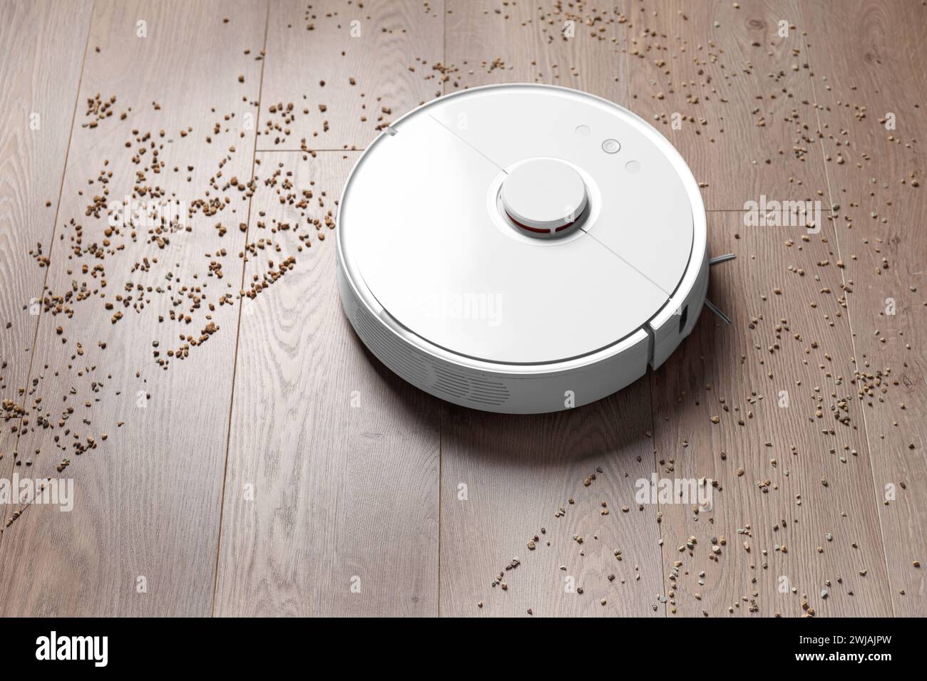 Smart robot vacuum cleaner removes scattered debris from the laminate floor. The concept of a smart home, wireless cleaning of any surfaces Stock Photo