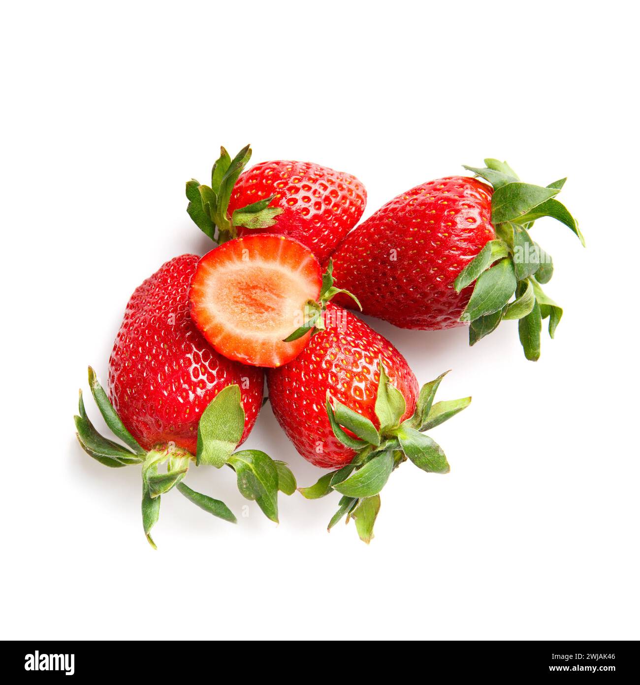 Fresh whole strawberries and half cut strawberries isolated on white background top view. Stock Photo