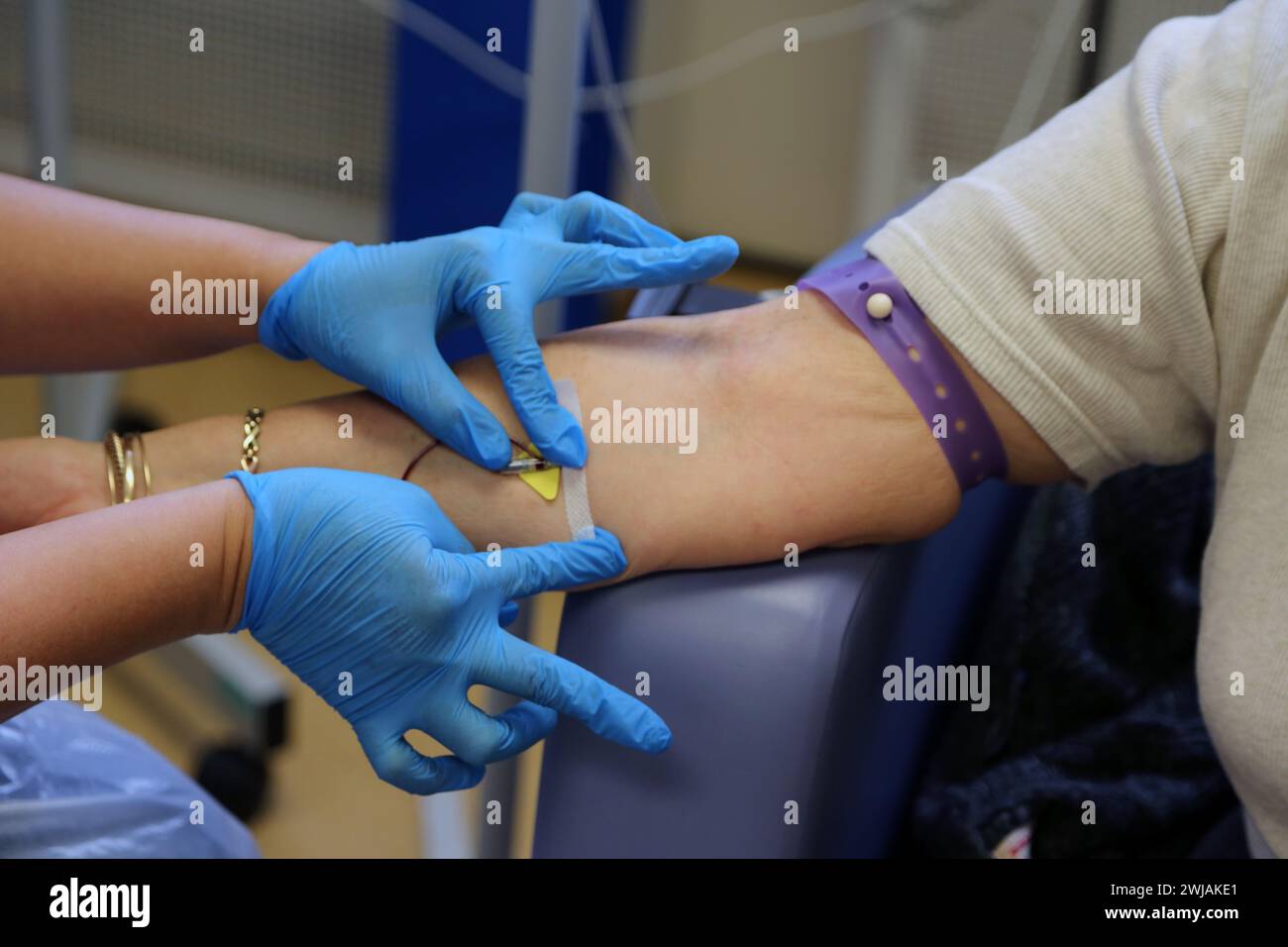 Nurse Inserting a Cannula into Patient Ready to Administer Ferinject