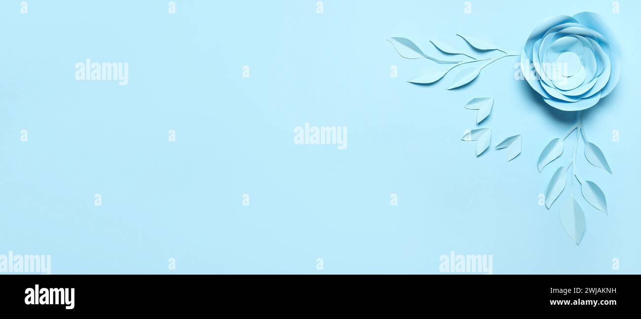 Beautiful paper flower and leaves on light blue background with space ...