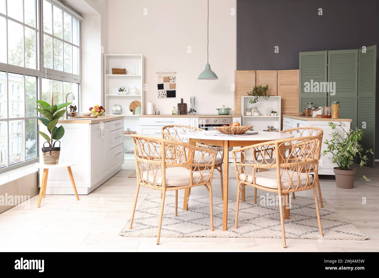 Interior of kitchen with dining table, counters and houseplants Stock ...