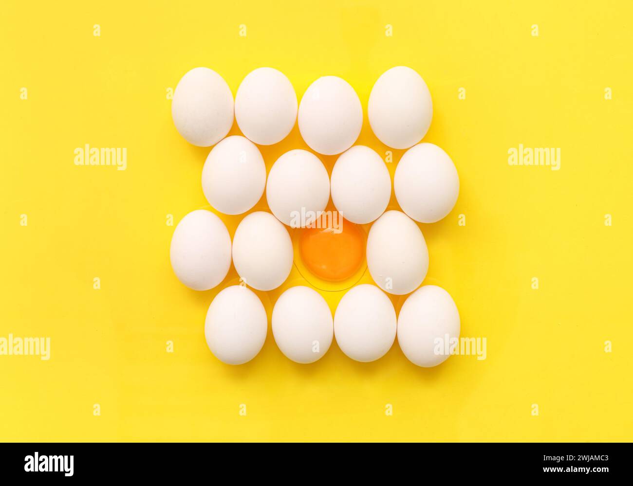 Cracked and whole chicken eggs on yellow background Stock Photo - Alamy