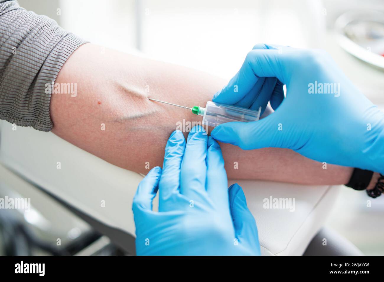 A nurse in the lab takes a blood test from a vein, a close-up plan without a face. Stock Photo