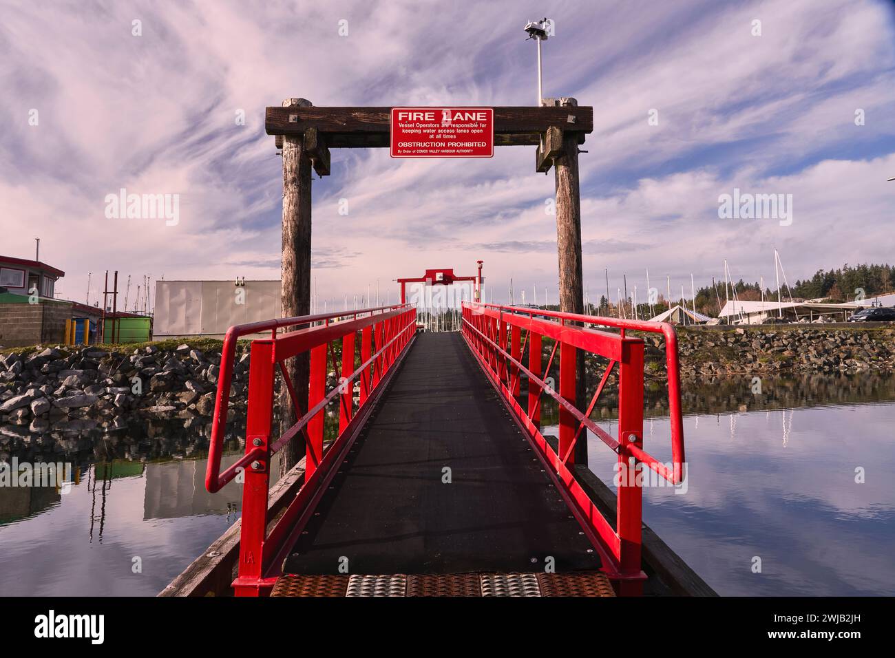 Walkway with bright red railings against a dramatic sky and the ...