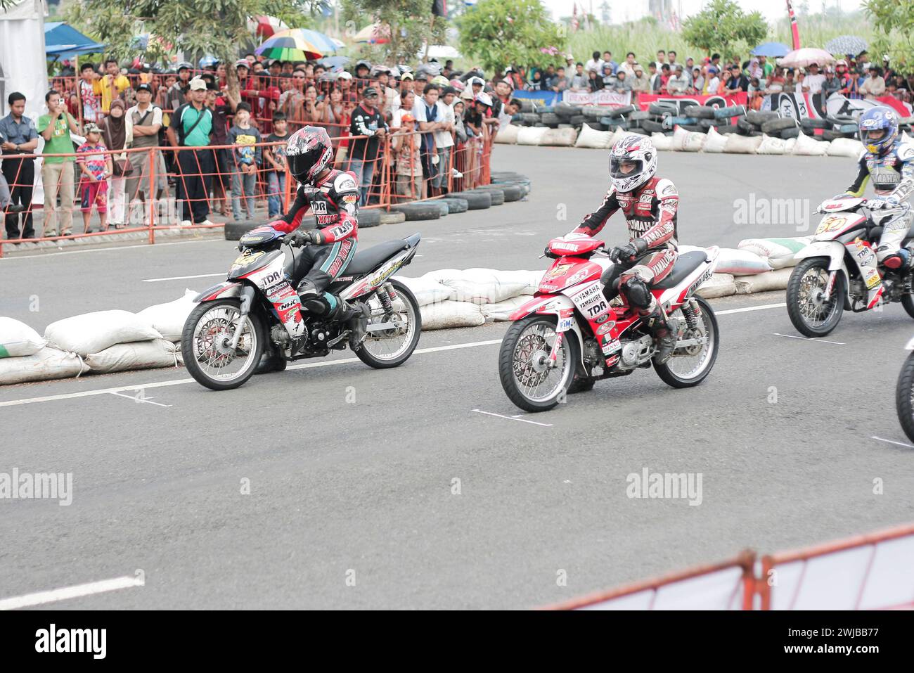 Underbone motorbike racers on start line motor sport racing circuit in Kediri, East Java, Indonesia Stock Photo