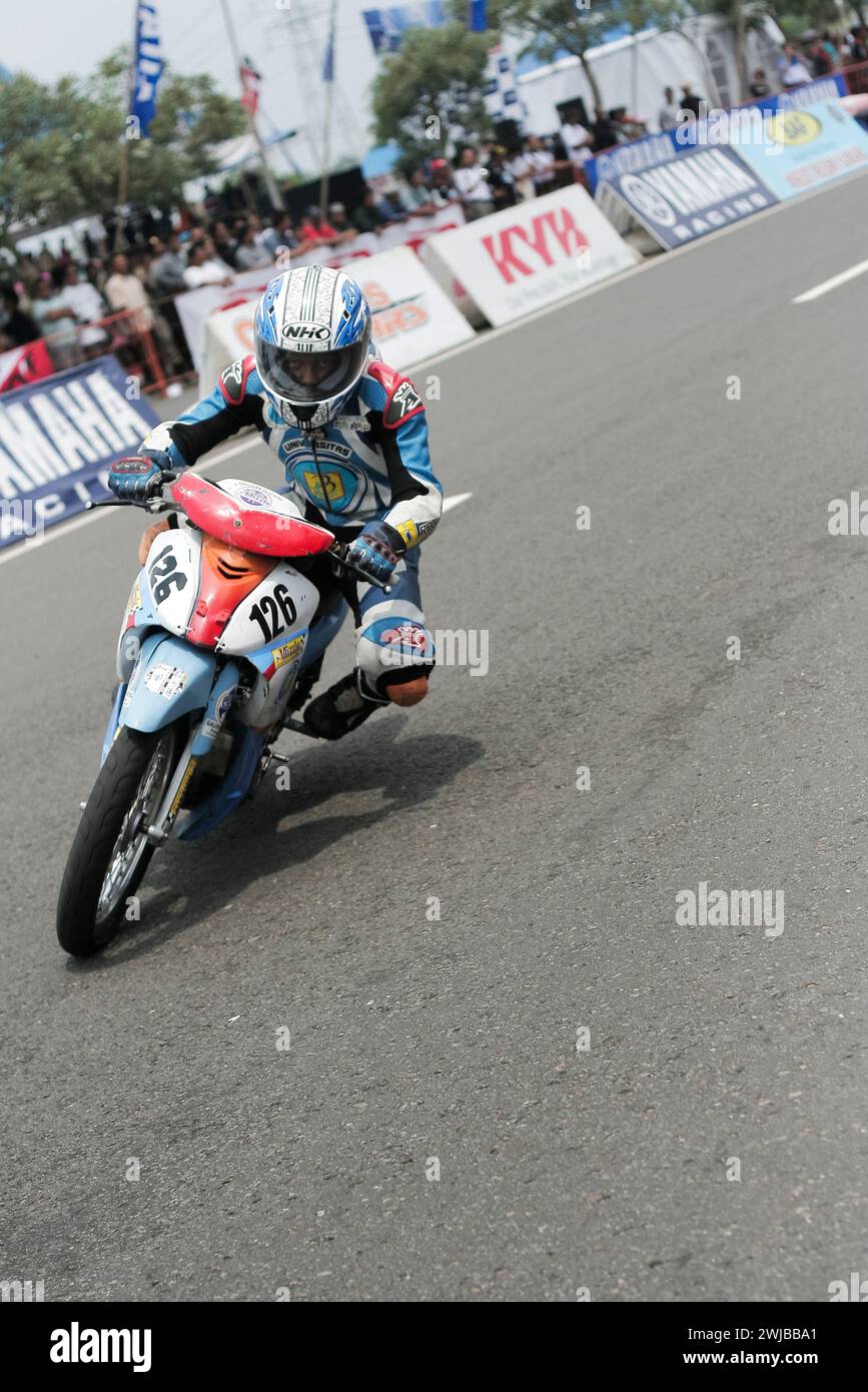 Underbone motorbike racer riding on racing track in Kediri, East Java, Indonesia. Stock Photo