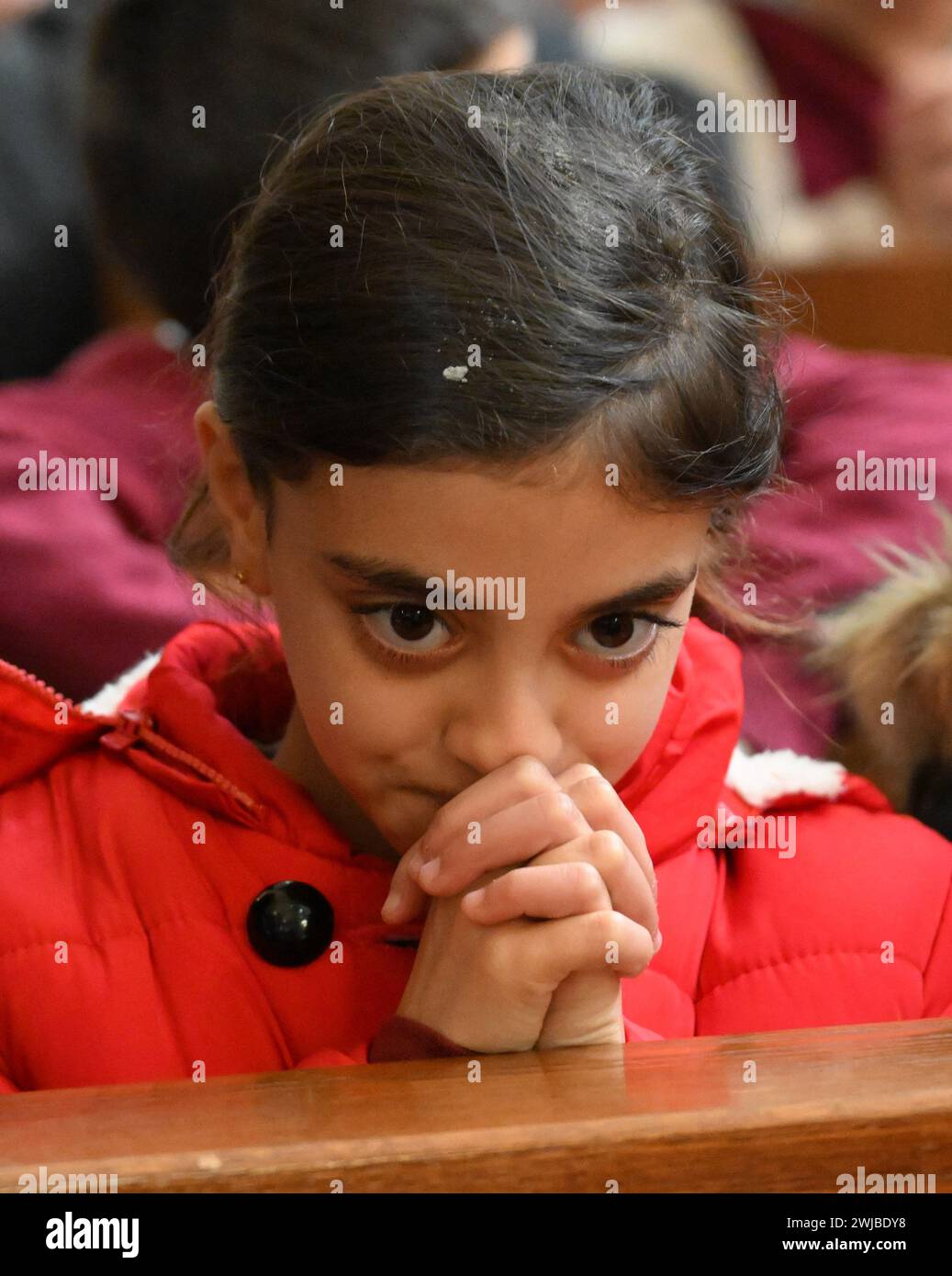 Bethlehem, West Bank. 14th Feb, 2025. A Palestinian Catholic girl prays