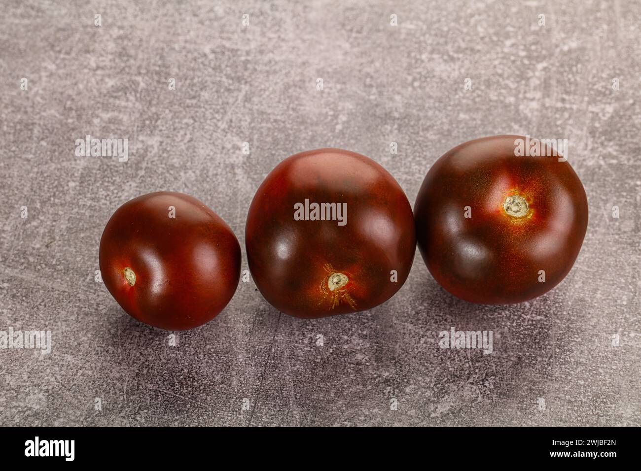 Organic natural juicy ripe Kumato tomato Stock Photo Alamy