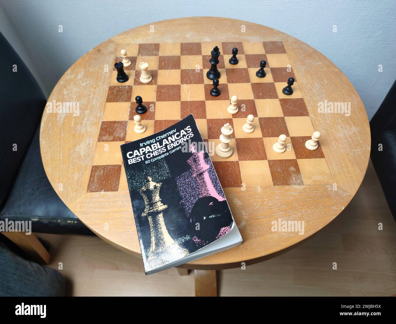 Studying Chess with a Chessboard and Chessbook Stock Photo