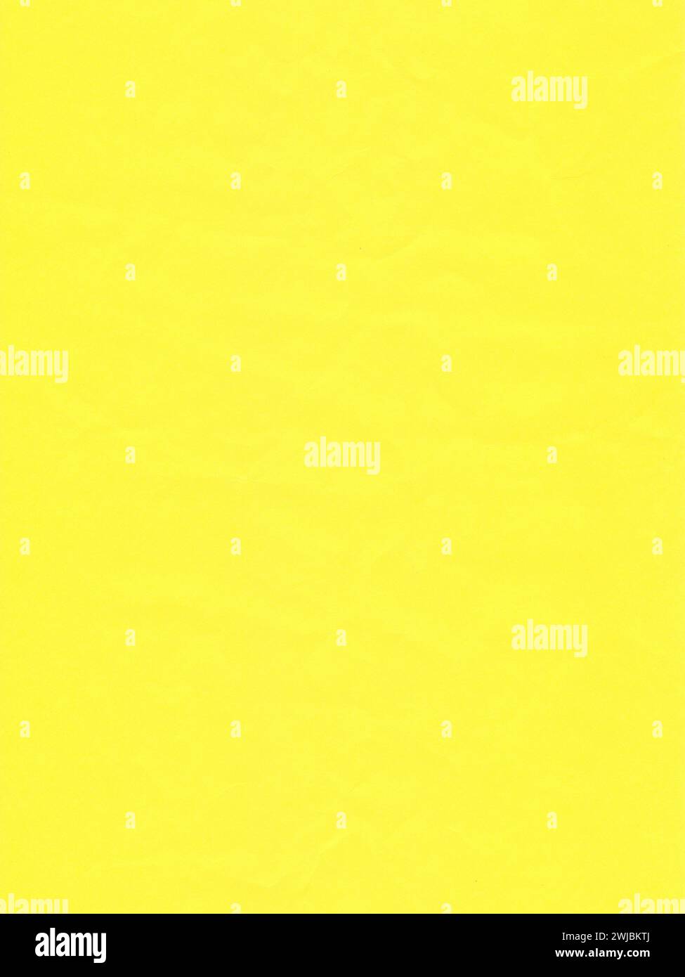 Texture of colored paper, surface of bright yellow crumpled sheet of paper Stock Photo