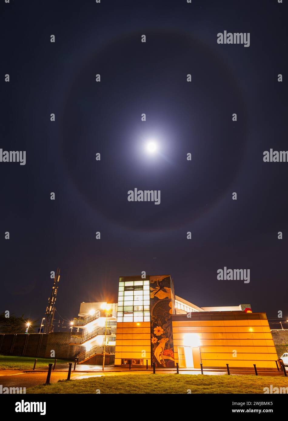 Bright lunar halo over Howth Junction & Donaghmede train station Stock Photo