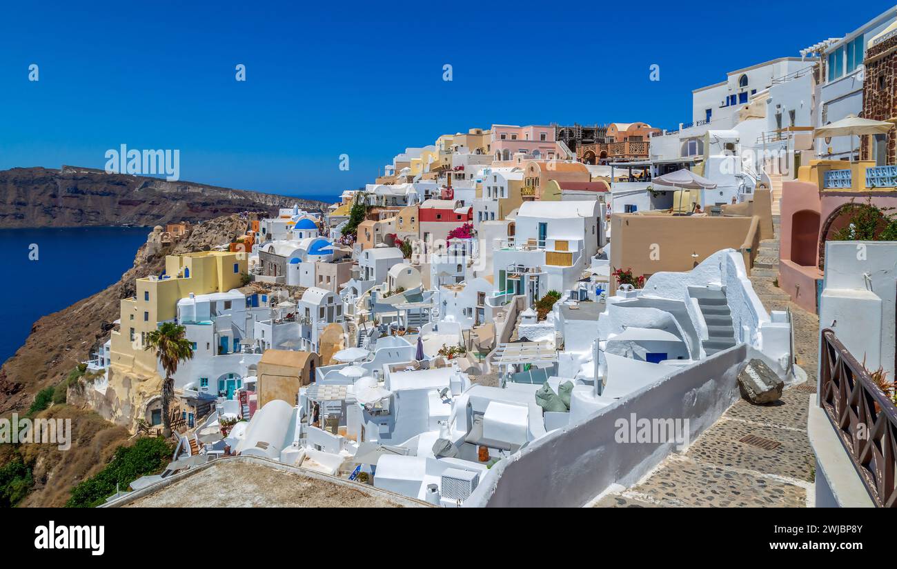 Typical white and blue architecture with domes, churches, hotels and restaurants of Oia village on Santorini island, Greece. Stock Photo