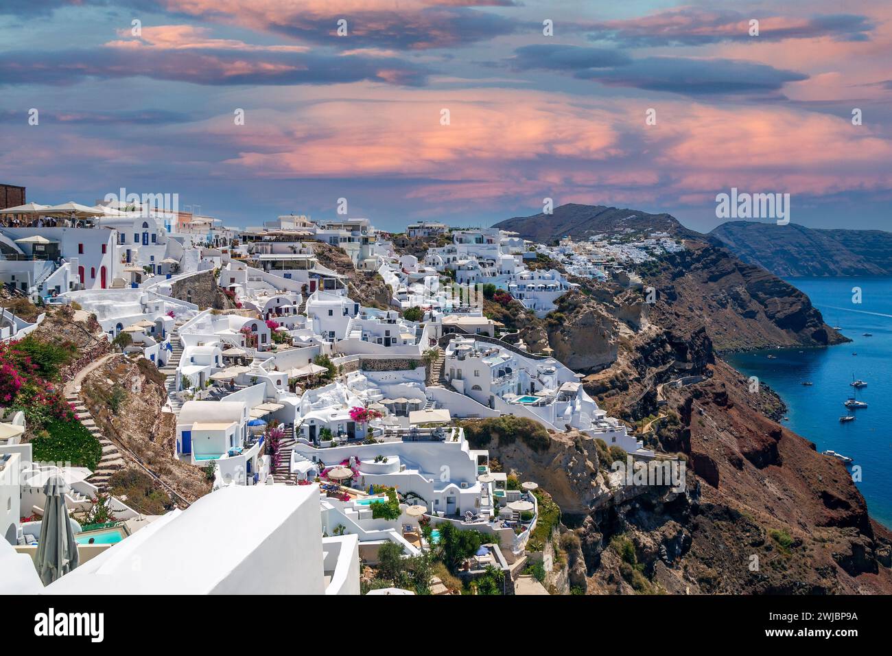 Typical white architecture with hotels and restaurants of Oia village on Santorini island, Greece. Stock Photo