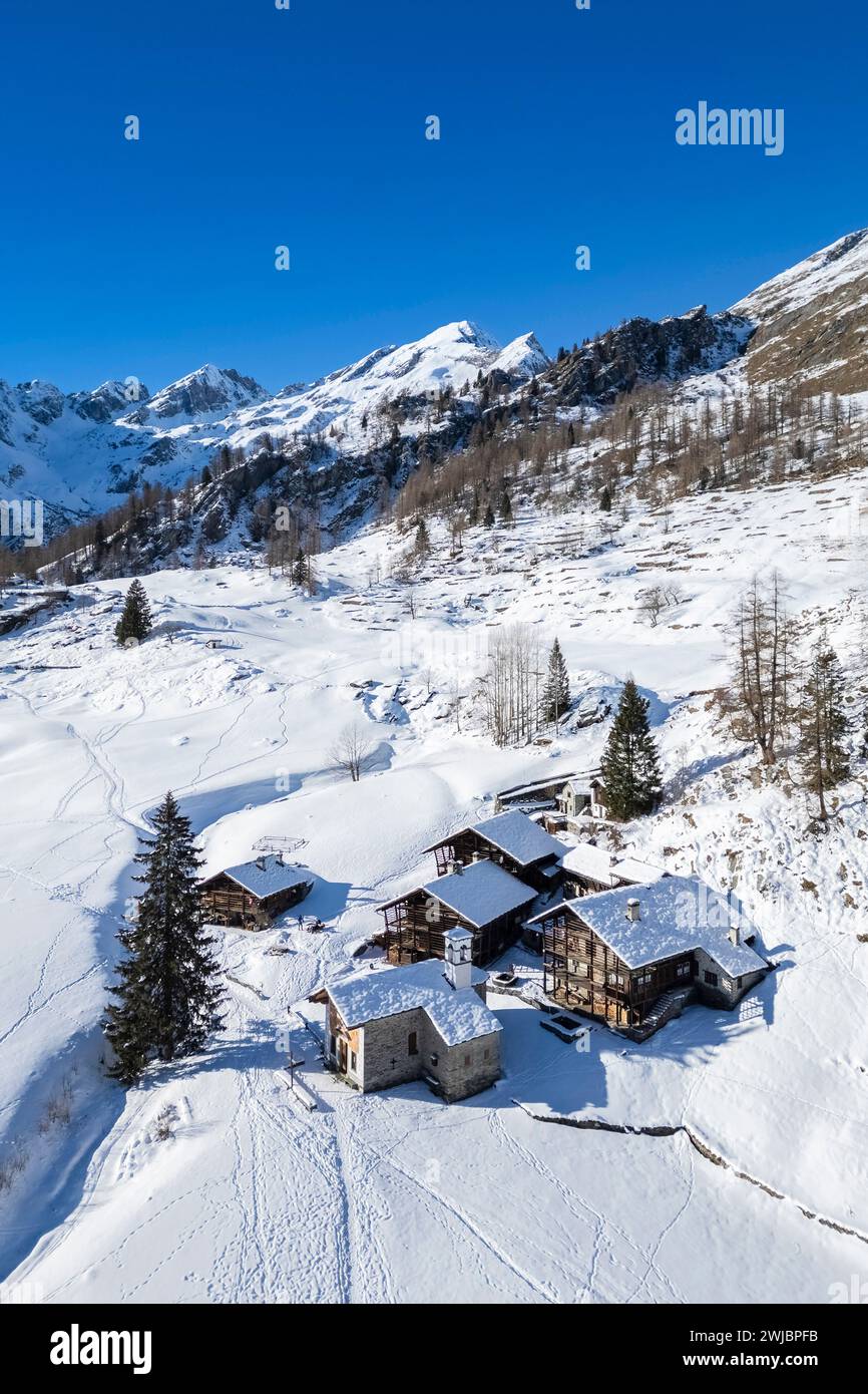 Aerial view of walser huts in Alpe Otro in winter. Alagna, Valsesia, Vercelli province, Piedmont, Italy, Europe. Stock Photo