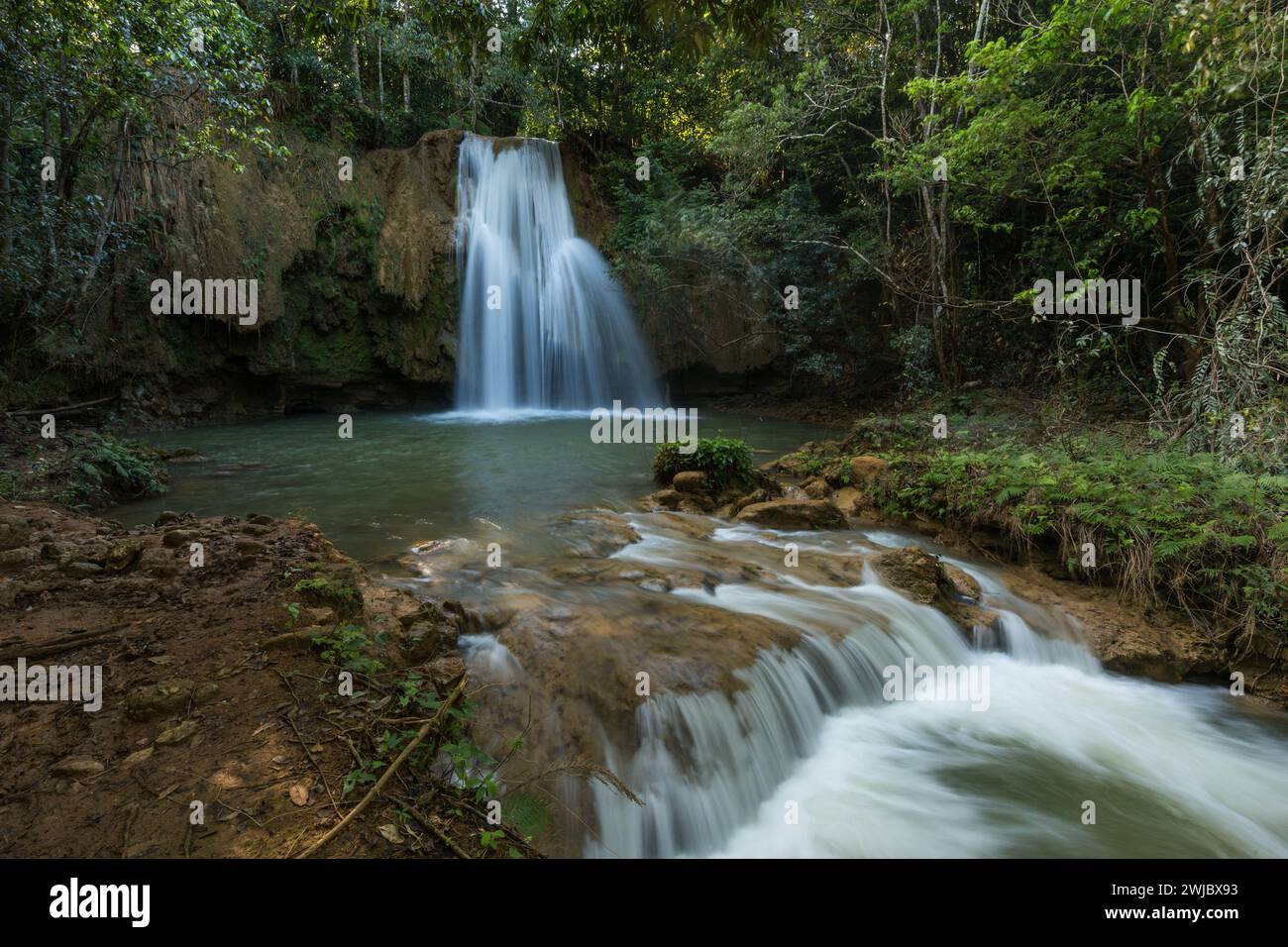 A smaller waterfall on the Limon River near the main waterfalls of El Limon in the  Dominican Republic.  A slow shutter speed was used to give the wat Stock Photo