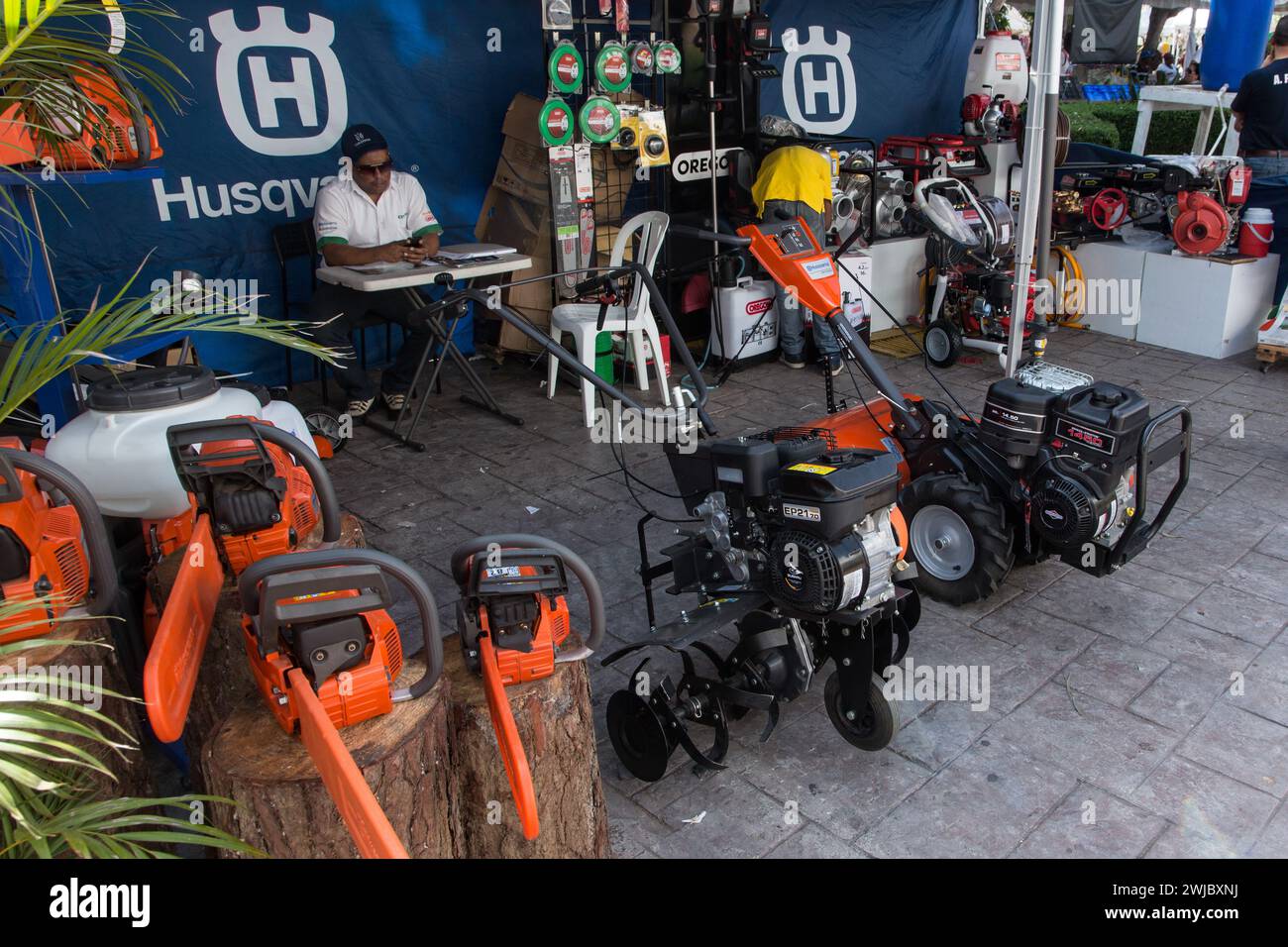 Tillers & chainsaws for sale at a booth at the Bani Mango Expo in Bani, Dominican Republic. Stock Photo