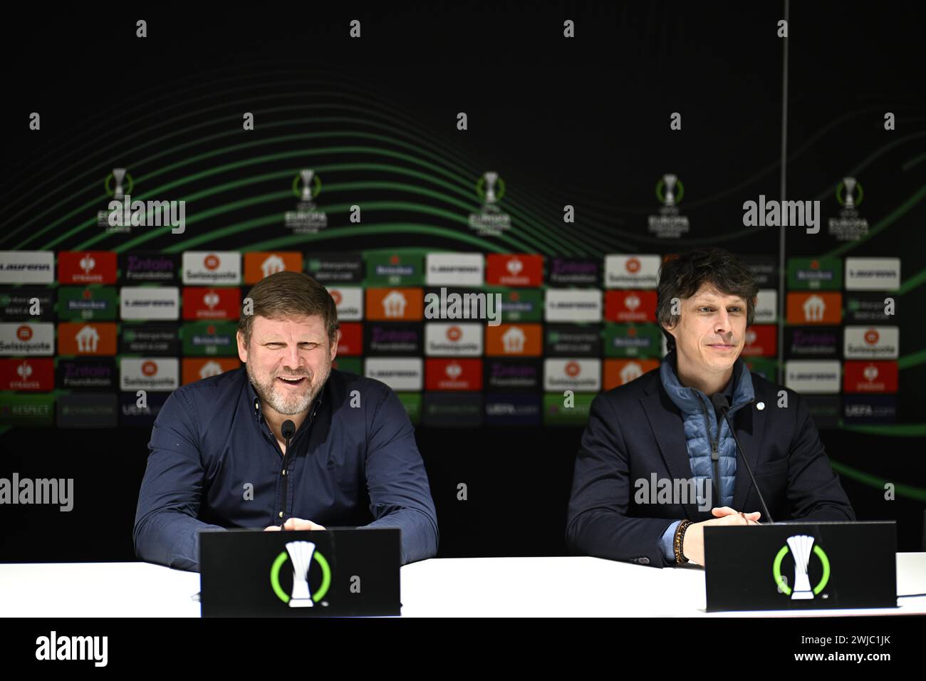 Budapest, Hungary. 14th Feb, 2024. Gent's head coach Hein Vanhaezebrouck and Gent's communications manager Tom Vandenbulcke pictured during a press conference of Belgian soccer club KAA Gent, on in Budapest, Hungary. The team is preparing for tomorrow's game against Israeli soccer team Maccabi Haifa, the first leg of the play offs phase of the UEFA Conference League competition. BELGA PHOTO JASPER JACOBS Credit: Belga News Agency/Alamy Live News Stock Photo