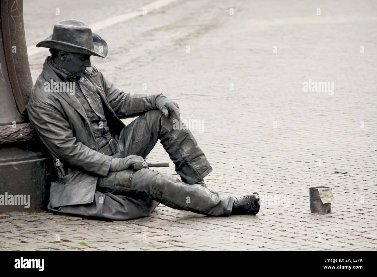 street artist impersonating a cowboy statue complete with a hat and pistol, adding a unique charm to the city’s atmosphere Stock Photo