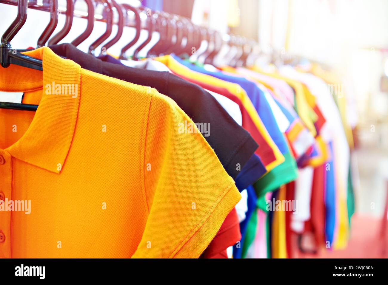 Fashion colored t-shirts on a hanger in a store Stock Photo