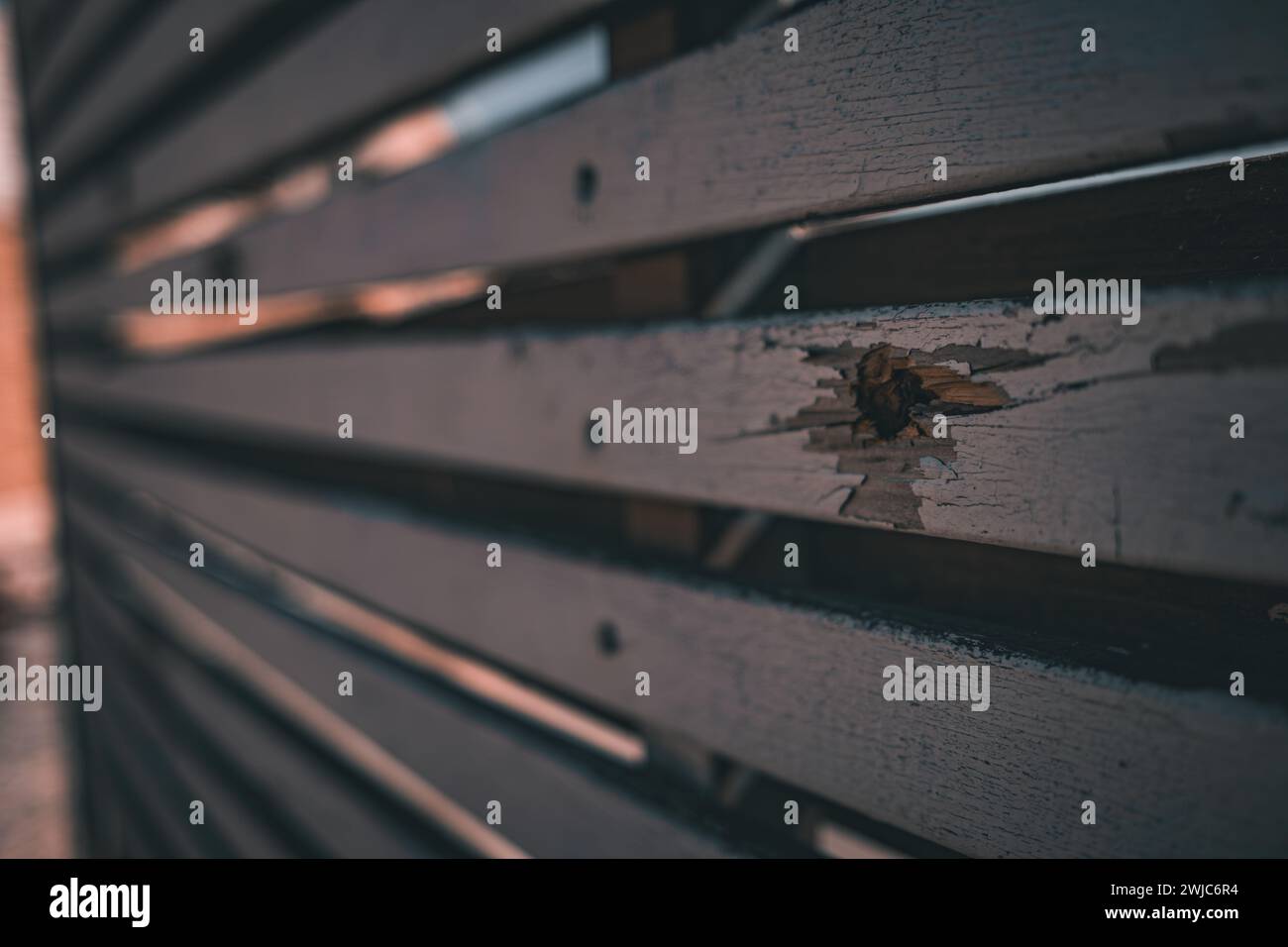 Close-up of a wooden fence in a Sderot neighborhood pockmarked with bullet holes, silent witness to the recent conflict. Stock Photo