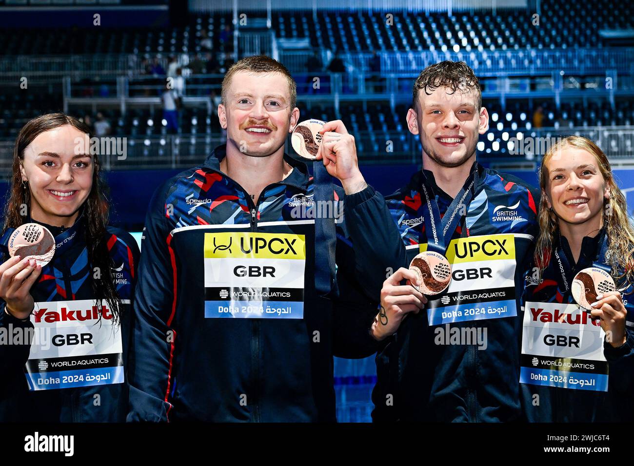 Doha, Qatar. 14th Feb, 2024. Team Great Britain shows the gold bronze after competing in the swimming 4X100 Medley Mixed Final during the 21st World Aquatics Championships at the Aspire Dome in Doha (Qatar), February 14, 2024. Credit: Insidefoto di andrea staccioli/Alamy Live News Stock Photo