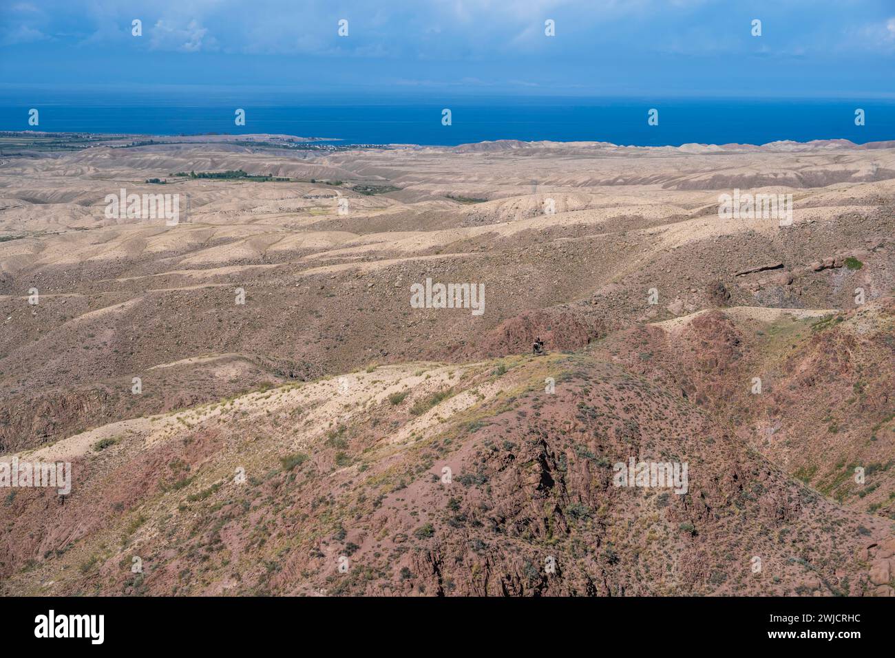 View of arid landscape and Issyk Kul Lake, Kyrgyzstan Stock Photo