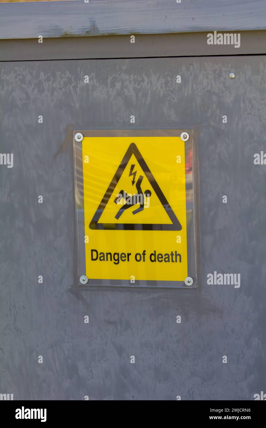 A warning sign. Danger of death. Danger of electrocution. On an electrical supply cabinet. Stock Photo