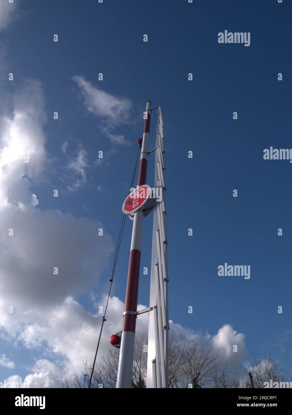Raised barrier with stop sign against a blue sky Stock Photo - Alamy