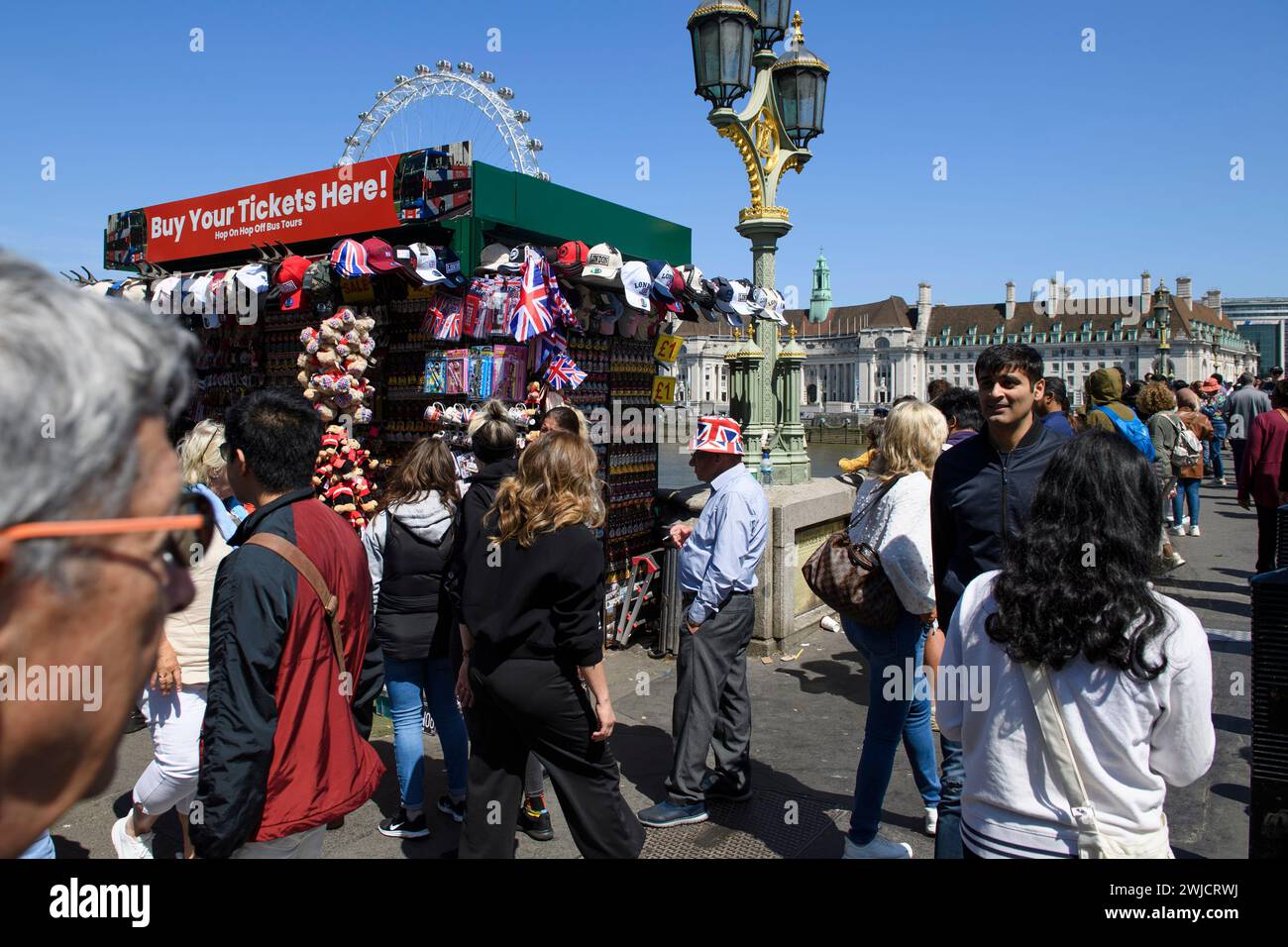 A tourist is standing around a souvenir stand located at the north end. of  Westminster Bridge, London, UK.  26 May 2023 Stock Photo