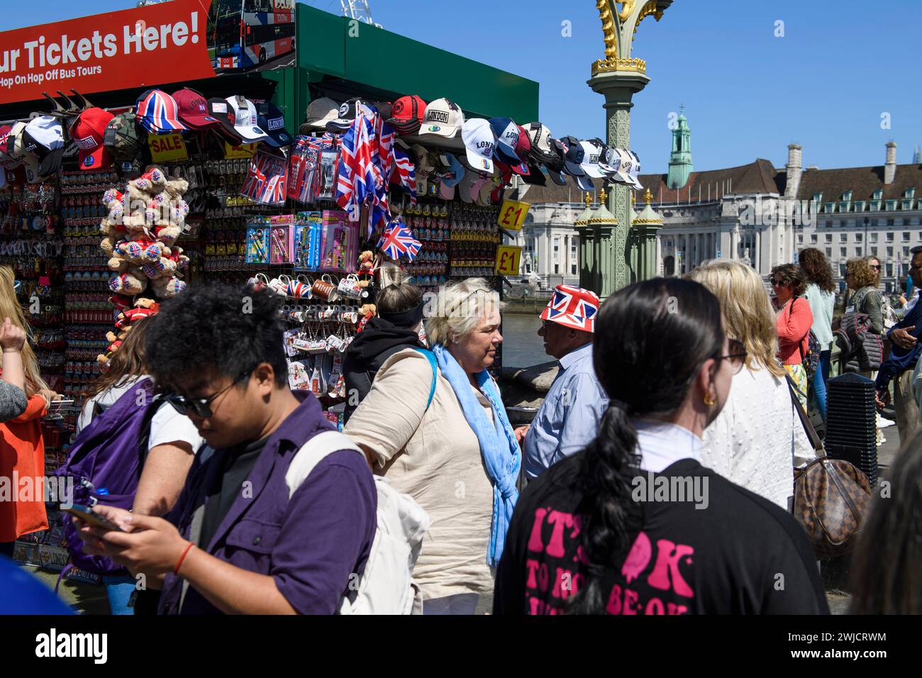 A tourist is standing around a souvenir stand located at the north end. of  Westminster Bridge, London, UK.  26 May 2023 Stock Photo