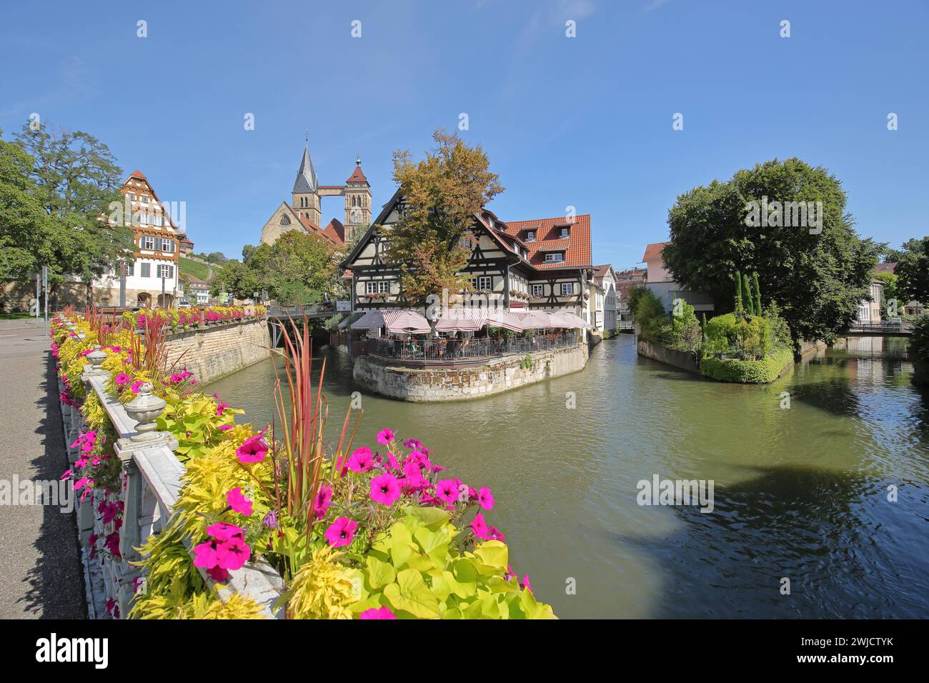 Agnes Bridge over the Rems with half-timbered house Restaurant Alte Zimmerei and Gothic town church St. Dionys River, bridge, bank, flower Stock Photo