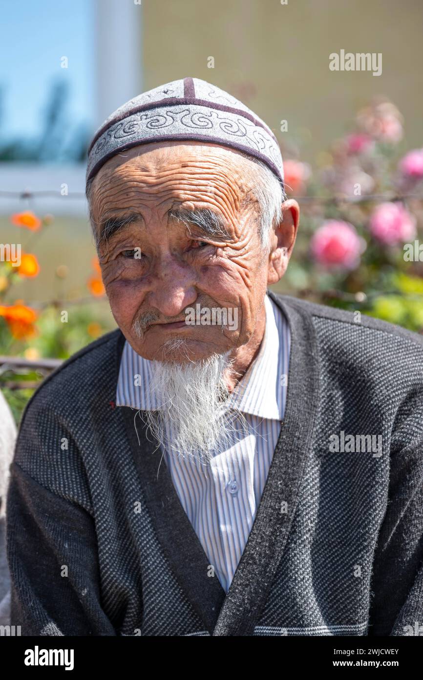 Portrait, local elderly man with traditional hat, Issyk-Kul region, Kyrgyzstan Stock Photo